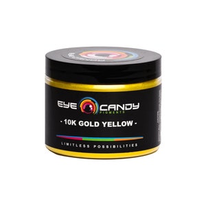 May include: A jar of 10K Gold Yellow pigment by Eye Candy Pigments. The jar is gold with black lettering and a logo of a colorful eye with the words "Eye Candy Pigments". The text on the jar reads "10K Gold Yellow" and "Limitless Possibilities".