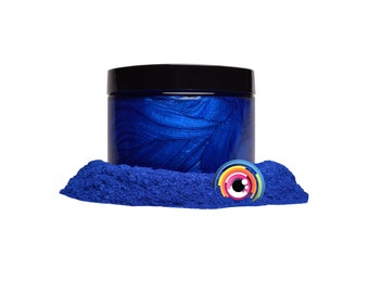 May include: A jar of blue metallic pigment powder. The powder is a deep blue color with a metallic sheen. The jar is made of clear glass and has a black lid.