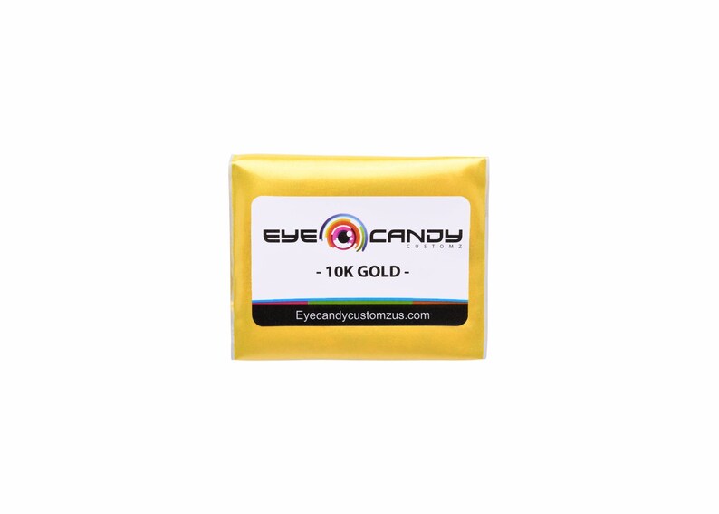 May include: A small, gold-colored package with the text "Eye Candy Customz" and "10K GOLD" on a white label. The website address "Eyecandycustomzus.com" is printed below the text.