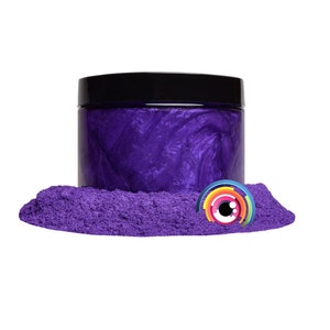 May include: A jar of purple iridescent mica powder. The powder is in a pile in front of the jar.