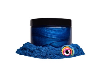 May include: A jar of blue metallic pigment powder. The powder is a deep blue color with a metallic sheen. The jar is made of clear glass with a black lid.