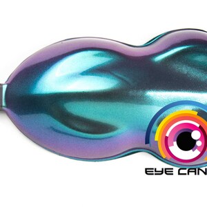 May include: A pearlescent, iridescent paint sample in shades of teal, purple, and blue. The product has a smooth, glossy finish and a unique color-shifting effect. The logo "EYE CANDY" is visible.