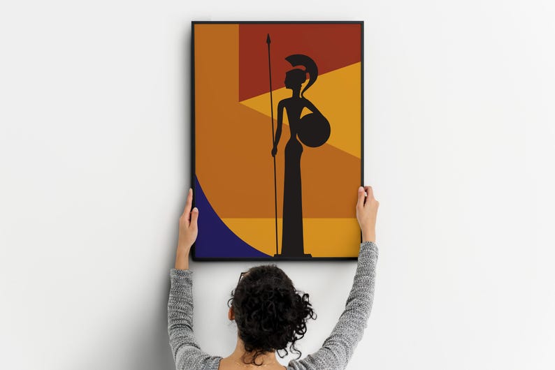 May include: A framed art print featuring a silhouette of a figure holding a spear and shield. The artwork is set against a geometric background of orange, yellow, and blue shapes. The figure is black, and the frame is black.