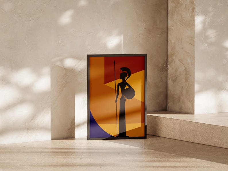 May include: Framed art print featuring a silhouette of a warrior figure with a spear and shield. The artwork has a geometric background with orange, yellow, and blue shapes. The frame is black, and the print is displayed against a neutral-toned wall.