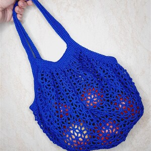 May include: A blue crocheted mesh bag with a drawstring closure. The bag is filled with red apples.