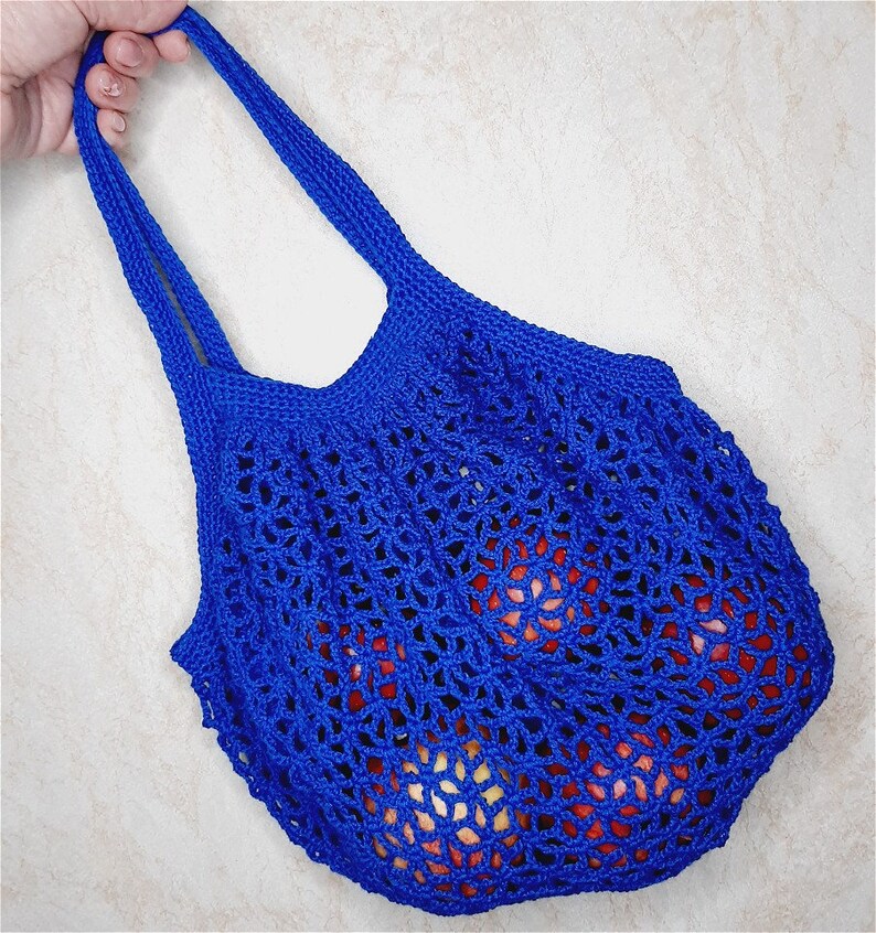 May include: A blue crocheted mesh bag with a drawstring closure. The bag is filled with red apples.
