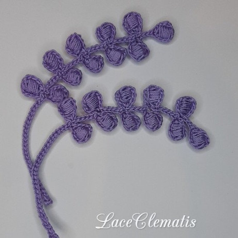 May include: A close-up of a purple crocheted lace trim with a delicate floral design. The trim is made of fine yarn and has a delicate, feminine look. The trim is perfect for adding a touch of elegance to any project.