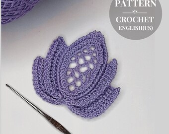 May include: A purple crochet flower pattern in English (US). The pattern is for a delicate, lacy flower with a center hole. The pattern is written in English (US).