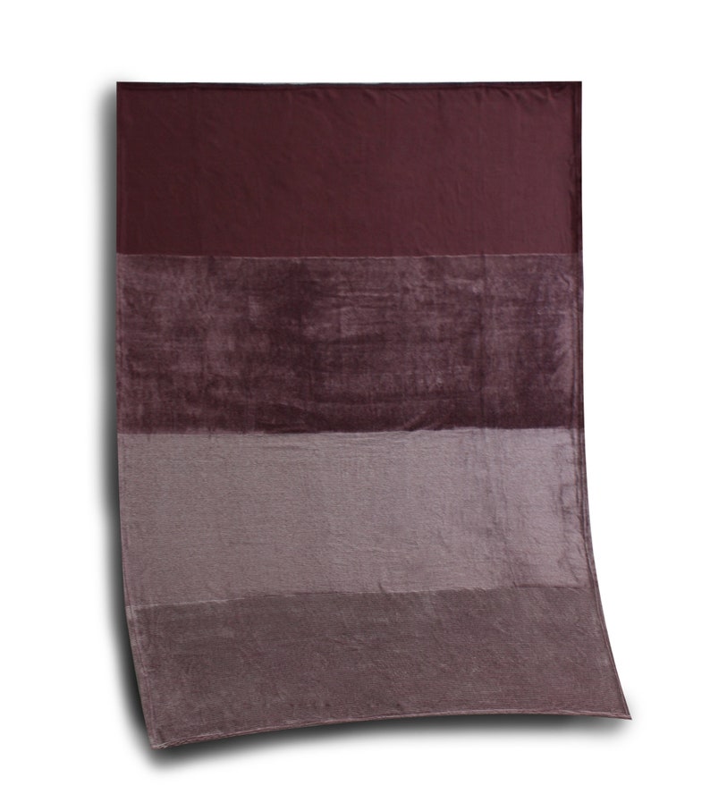 May include: A rectangular throw blanket featuring a color-blocked design with four horizontal bands in varying shades of deep burgundy, dark plum, muted mauve, and a lighter dusty purple, all rendered in a soft, plush, velvet-like fabric texture.