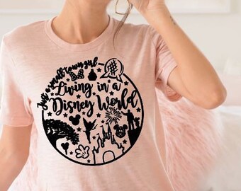 May include: A pink t-shirt with a black graphic design of a circle with the text "Living in a Disney World" and various Disney characters and symbols.