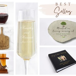 May include: A collection of personalized items including a stemless wine glass with gold rim, a wooden pizza peel, a beer horn with stand, a champagne flute, a memorial stone with tree graphic, and a black photo album with custom text.
