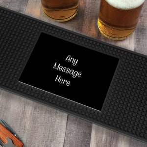 May include: Black bar mat with a black square in the center that says "Any Message Here".