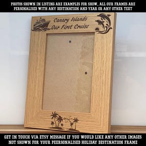 May include: A light brown wooden picture frame with a vertical orientation. The top border features an engraved cruise ship, the text "Canary Islands Our First Cruise," and two jumping dolphins. The bottom border displays an engraved palm tree scene.