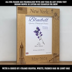 May include: A light oak wooden photograph frame featuring laser-engraved New York City landmarks including the Statue of Liberty, Empire State Building, and Brooklyn Bridge, with the text New York and May 2024, sized 203 mm by 152 mm.