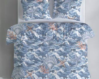 Capa de edredom com estampa de ondas e conchas, estilo náutico, com design de estrelas-do-mar e vieiras em tons de azul, perfeita para casa de praia. Inclui fronhas.