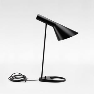 May include: A sleek, black desk lamp with a conical shade and a slender, vertical support. The lamp features a circular base and a power cord. The design is minimalist and modern, suitable for a workspace or bedside table.
