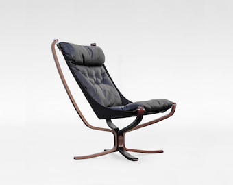 May include: A black leather swivel chair with a wooden frame. The chair has a high back and a comfortable seat.