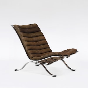 Sillón Ari Sling vintage de acero y cuero marrón, Arne Norell AB, icono original de los años 60, estilo minimalista moderno escandinavo de mediados de siglo.