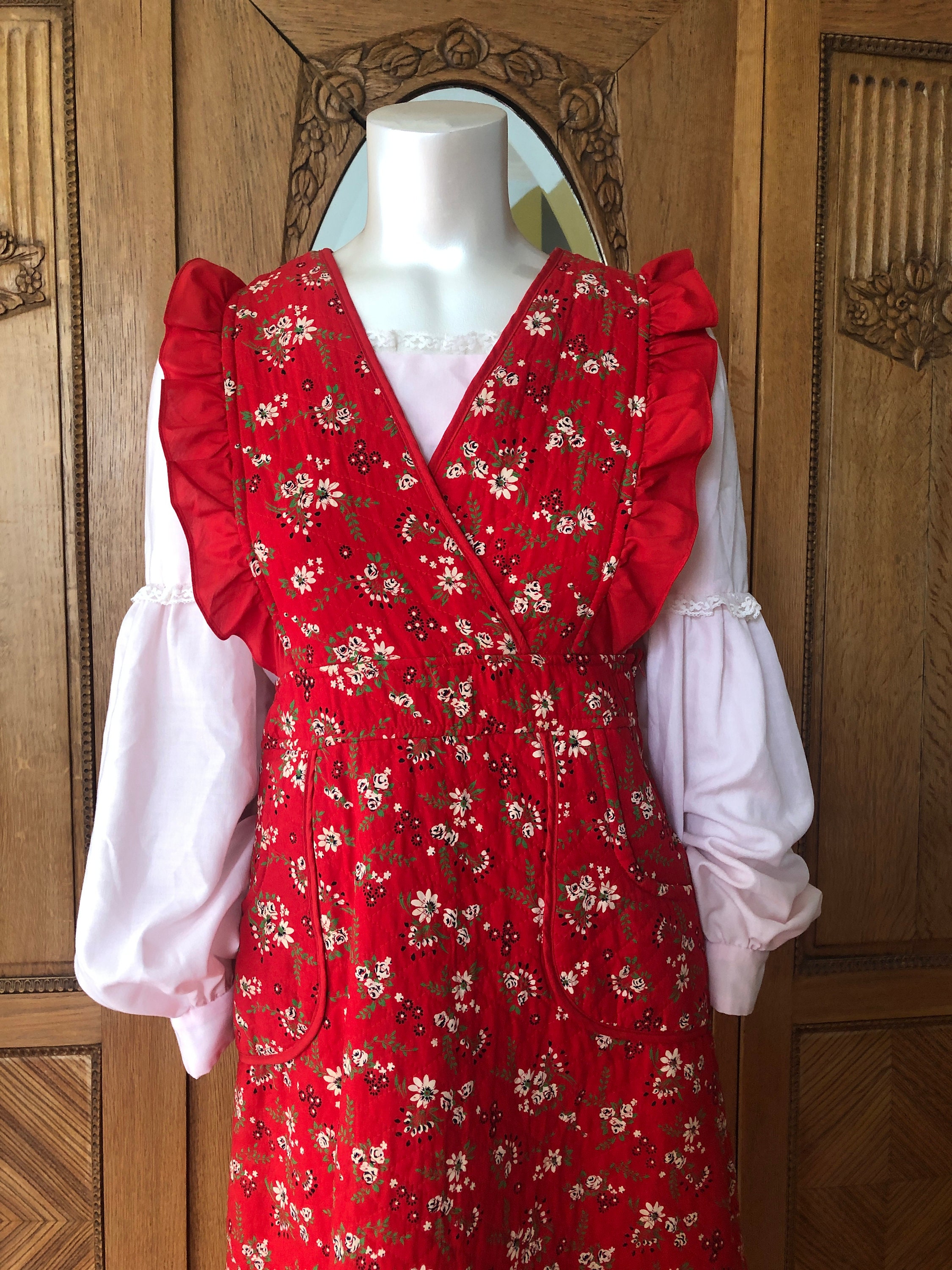 Vintage Aprons, Retro Aprons, Old Fashioned Aprons & Patterns 70s Quilted Dress in Red Calico Vintage Surplice Hippie Apron $80.32 AT vintagedancer.com