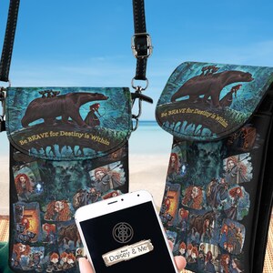 May include: Two crossbody cell phone bags with a colorful illustration featuring a bear, a woman with red hair, and the text "Be BRAVE for Destiny is Within." One bag is open, and a phone with the "Daisey & Me" logo is visible.