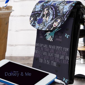 May include: A black phone case with a blue and white floral design. The case features a quote from the movie "The Corpse Bride" that reads: "With this hand, I will lift your sorrows. Our cup will never empty, for I will be your wine. With this candle, I will light your way in darkness. With this ring, I ask you to be mine."