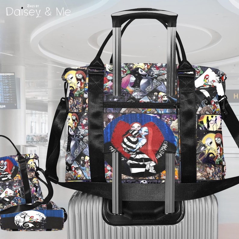 May include: A black and multi-coloured tote bag featuring characters from "The Nightmare Before Christmas." The bag has a black handle and shoulder strap. The design includes a zipped front pocket and is set on top of a silver rolling suitcase.