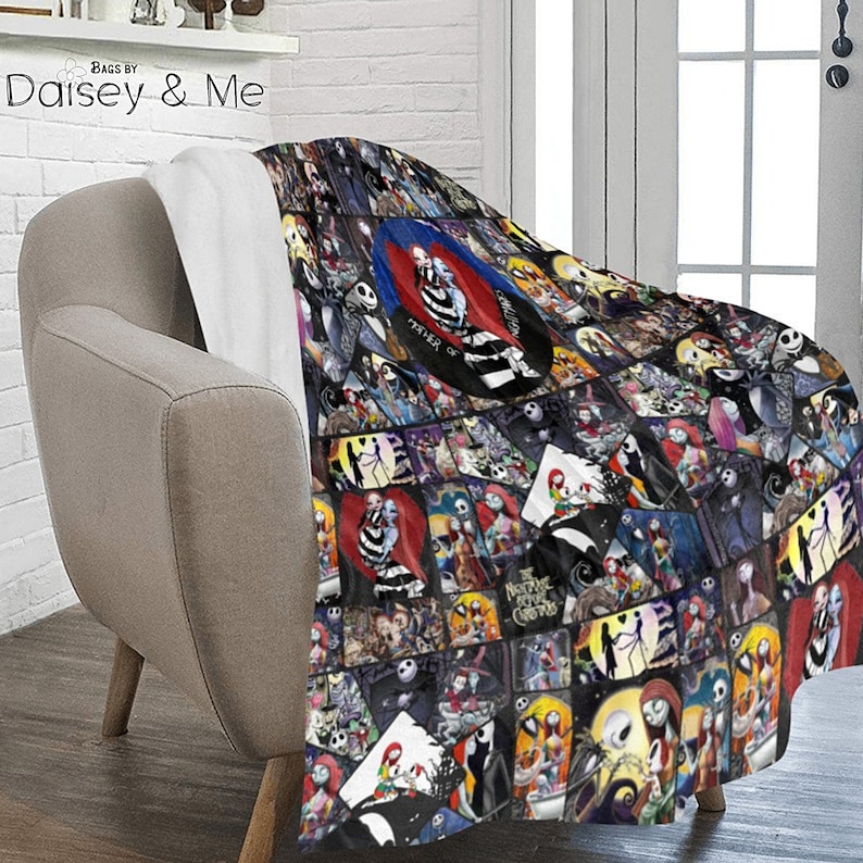May include: A black and white fleece blanket with a collage of images from the movie "The Nightmare Before Christmas". The blanket features characters like Jack Skellington, Sally, and Oogie Boogie. The blanket is folded and draped over a chair.