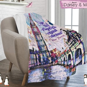May include: A colorful throw blanket with a watercolor painting of Big Ben and the Houses of Parliament in London. The blanket features the quote "Supercalifragilisticexpialidocious" from the movie Mary Poppins.