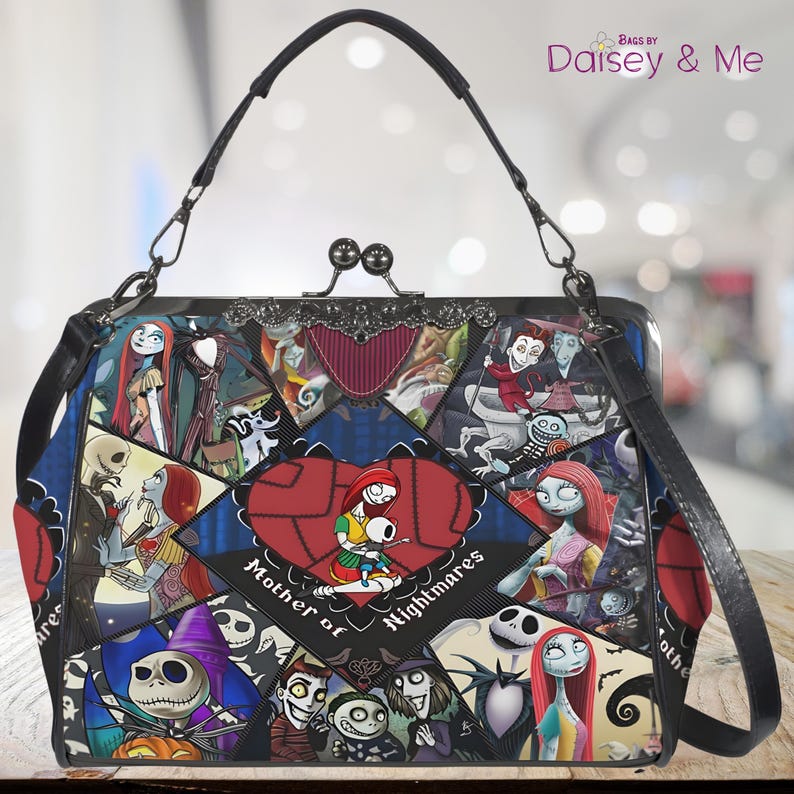 May include: A black handbag with a clasp closure and a shoulder strap. The bag features a patchwork design with various characters and the text "Mother of Nightmares" in a heart-shaped design. The bag has a black handle and silver hardware.