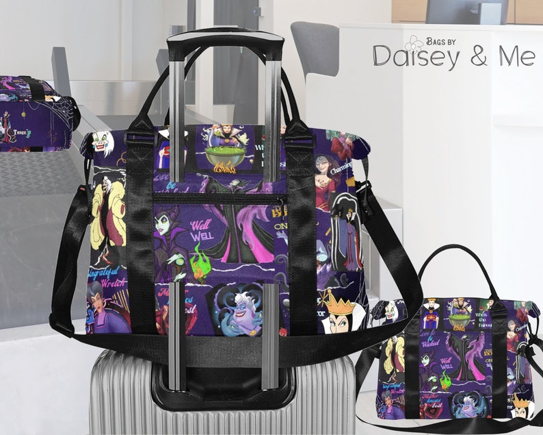 May include: Two purple and black travel bags featuring a print of Disney villains. The larger bag has a handle and a shoulder strap. The smaller bag has a handle. Both bags have the text "Well Well" printed on them.