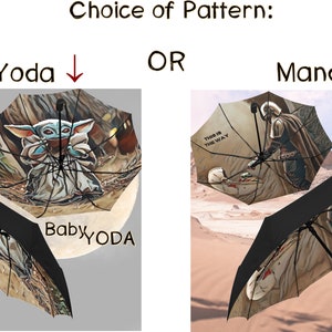 Pode incluir: Duas imagens de guarda-chuvas com designs diferentes. O primeiro guarda-chuva apresenta uma imagem de desenho animado de Baby Yoda da s&eacute;rie Star Wars. O segundo guarda-chuva apresenta uma imagem de desenho animado de Mandalorian da s&eacute;rie Star Wars. Ambos os guarda-chuvas t&ecirc;m o texto "This is the way" impresso neles.