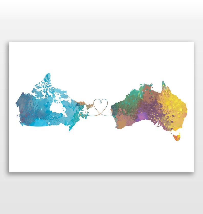 May include: Watercolor print featuring the maps of Canada and Australia connected by a heart-shaped line. The Canadian map is blue and teal, while the Australian map is a mix of yellow, green, and purple. The background is white.
