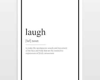 Puede incluir: Una impresión enmarcada con fondo blanco y borde negro. La palabra "laugh" está centrada en la parte superior, seguida de su pronunciación y definición. La definición describe los sonidos y movimientos espontáneos de la cara y el cuerpo.