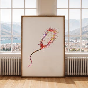 May include: A framed watercolor print of a colorful bacteria cell. The artwork features a vibrant mix of red, orange, yellow, and purple hues, with a long, curved tail. The print is displayed in a wooden frame.