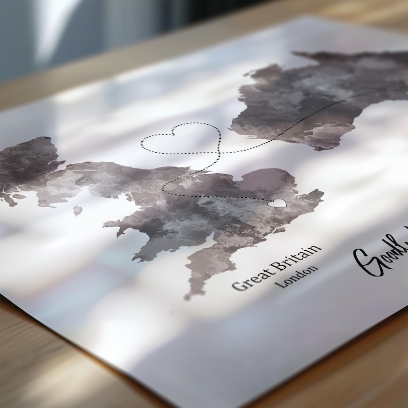 May include: A grayscale map of Great Britain with a dotted line connecting two locations, forming a heart shape. The words "Great Britain" and "London" are printed on the map. The overall theme is travel and relationships.