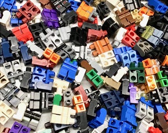 May include: A large collection of colorful Lego minifigure legs in various colors, including blue, red, green, yellow, black, white, and brown.