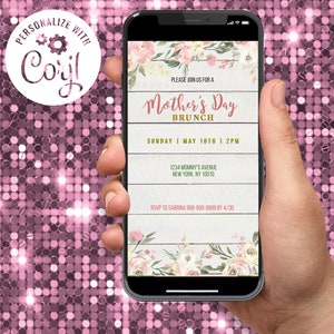 May include: A smartphone screen shows a Mother's Day Brunch invitation. The design incorporates floral elements, a wooden plank backdrop, and the words "Mother's Day Brunch" in a stylish font. The invitation includes date, time, and RSVP details.
