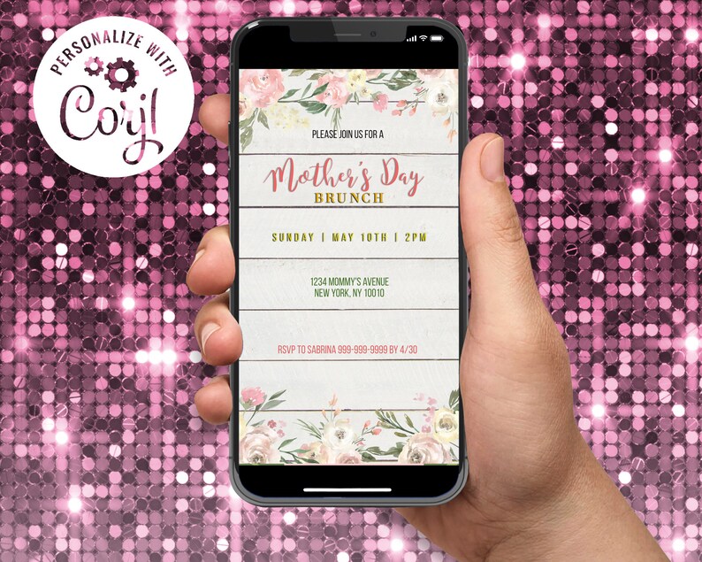 May include: A smartphone screen shows a Mother's Day Brunch invitation. The design includes floral elements, a wooden plank backdrop, and the text "Mother's Day Brunch." The invitation provides date, time, and RSVP details. The phone is held in a hand.