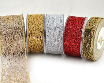 May include: Five spools of decorative ribbon with a glittery, mesh-like texture. The ribbon colors are gold, gold, silver, red, and gold.