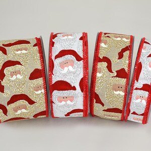 May include: Four spools of Christmas ribbon with a Santa Claus design. The ribbon shows Santa's face and hat in red, white, and beige. The edges are trimmed with red stitching. Ideal for festive crafts and gift wrapping.