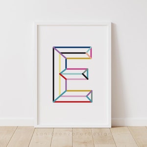 May include: A white framed print of the letter E made of colorful lines. The letter is in a geometric style and is centered on a white background. The print is signed "sanlorenzoForDesign" in the bottom center.