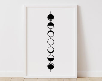 May include: A framed print featuring a minimalist design of the phases of the moon in black and white. The artwork displays the lunar cycle in a vertical line, with each phase represented by a circle or crescent shape. The frame is white.