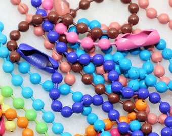 May include: A collection of colorful beaded chains with metal clasps. The chains are in various colors, including yellow, orange, pink, purple, blue, green, brown, black, and white.