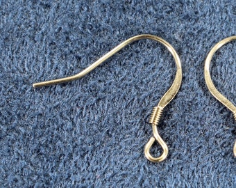 May include: Two gold-toned earring hooks with a wire loop at the top and a small, coiled wire at the bottom.
