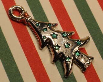 May include: Silver charm in the shape of a Christmas tree with green glitter stars.