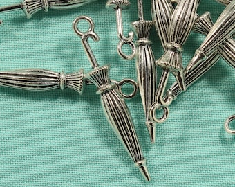 May include: A group of silver-toned metal umbrella charms. The charms are detailed with a ribbed umbrella design and a loop for attaching to a bracelet or necklace.