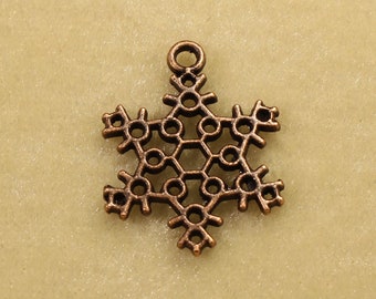 May include: A copper-colored snowflake charm with a detailed design. The charm has a loop at the top for attaching to a necklace or bracelet.