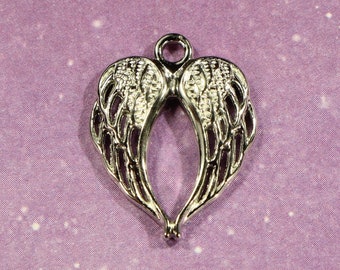 May include: Silver charm in the shape of angel wings, with a detailed design. The wings are joined at the top to form a heart shape.