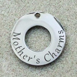 May include: A silver charm with the words "Mother's Charms" engraved around the edge.