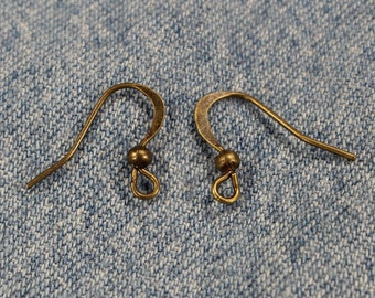 May include: Two gold-toned earring hooks with a small ball at the top of each hook.